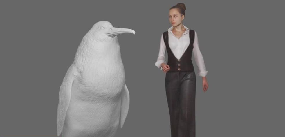 A life-size model of a giant fossil penguin standing next to a person