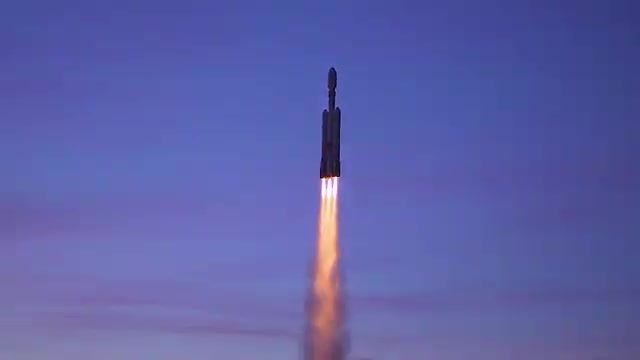 A model rocket climbing with a bright exhaust flame.