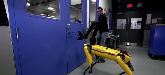 Yellow quadruped robot on a workshop floor