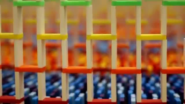 Rows of colored dominoes standing in a tight grid.