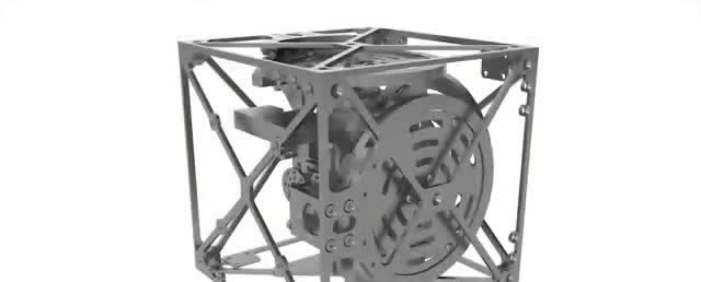 A metal cube with a wheel inside.