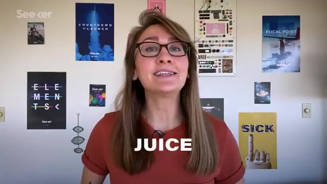 Scientist in front of posters about the JUICE mission to Jupiter’s moons