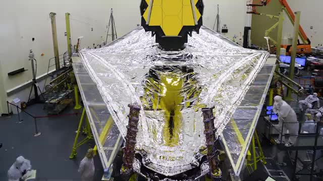 The James Webb Space Telescope sunshield spread open in a clean room