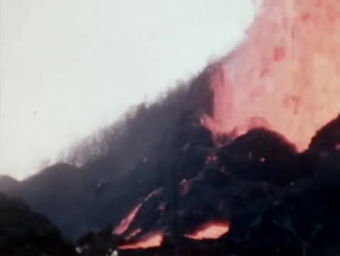 Lava and ash rising from a volcanic slope.