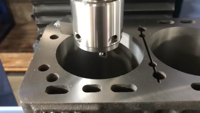 Metal printer head over a machined metal block