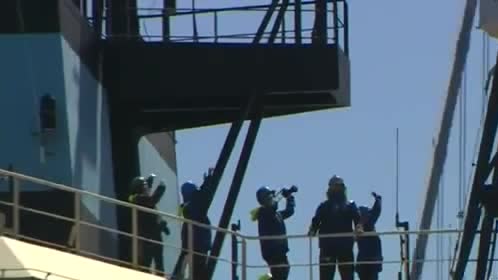 Crew on the deck of a ship leaving for the ocean cleanup.