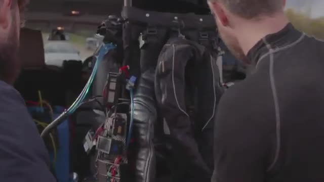 A jet suit hanging inside a vehicle.