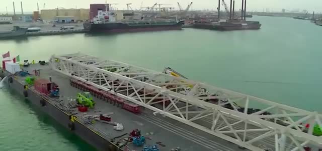 A long white wheel truss on a barge.