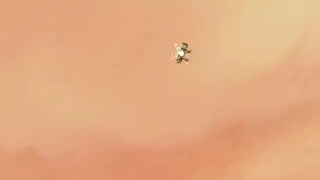 A small rotorcraft flying through orange haze