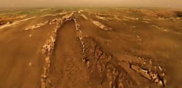 River channels cut into Titan's orange surface.
