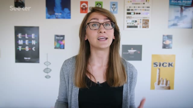 Scientist explaining the Emirates Mars mission in front of space posters