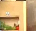 A clay cabinet with an open shelf of vegetables, used as an unpowered cooler.