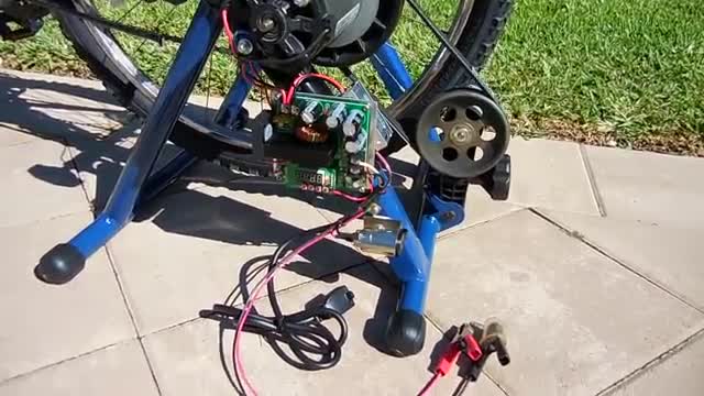 A bicycle on a stationary trainer wired to a generator