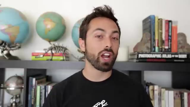 Presenter explaining information in front of a bookshelf