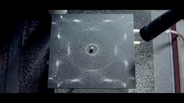 Sand forming a pattern on a vibrating plate.