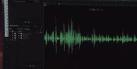 A green audio waveform on a dark screen.