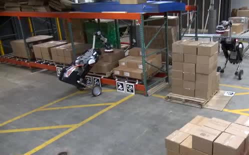 Wheeled warehouse robots moving stacks of boxes