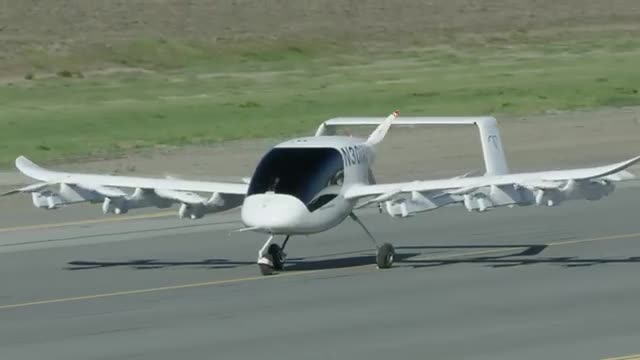A white multi-rotor aircraft on a runway.
